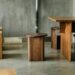 a group of wooden tables and stools in a room